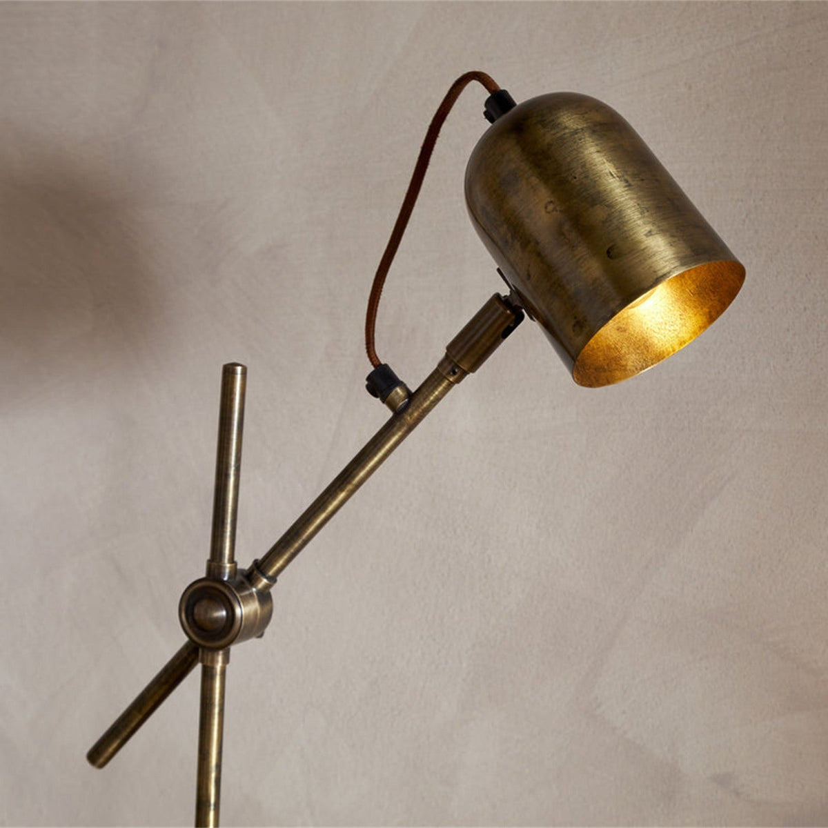 Thenkara Directional Desk Lamp - Antique Brass in a study, view 3