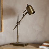 Thenkara Directional Desk Lamp - Antique Brass in a study, view 8