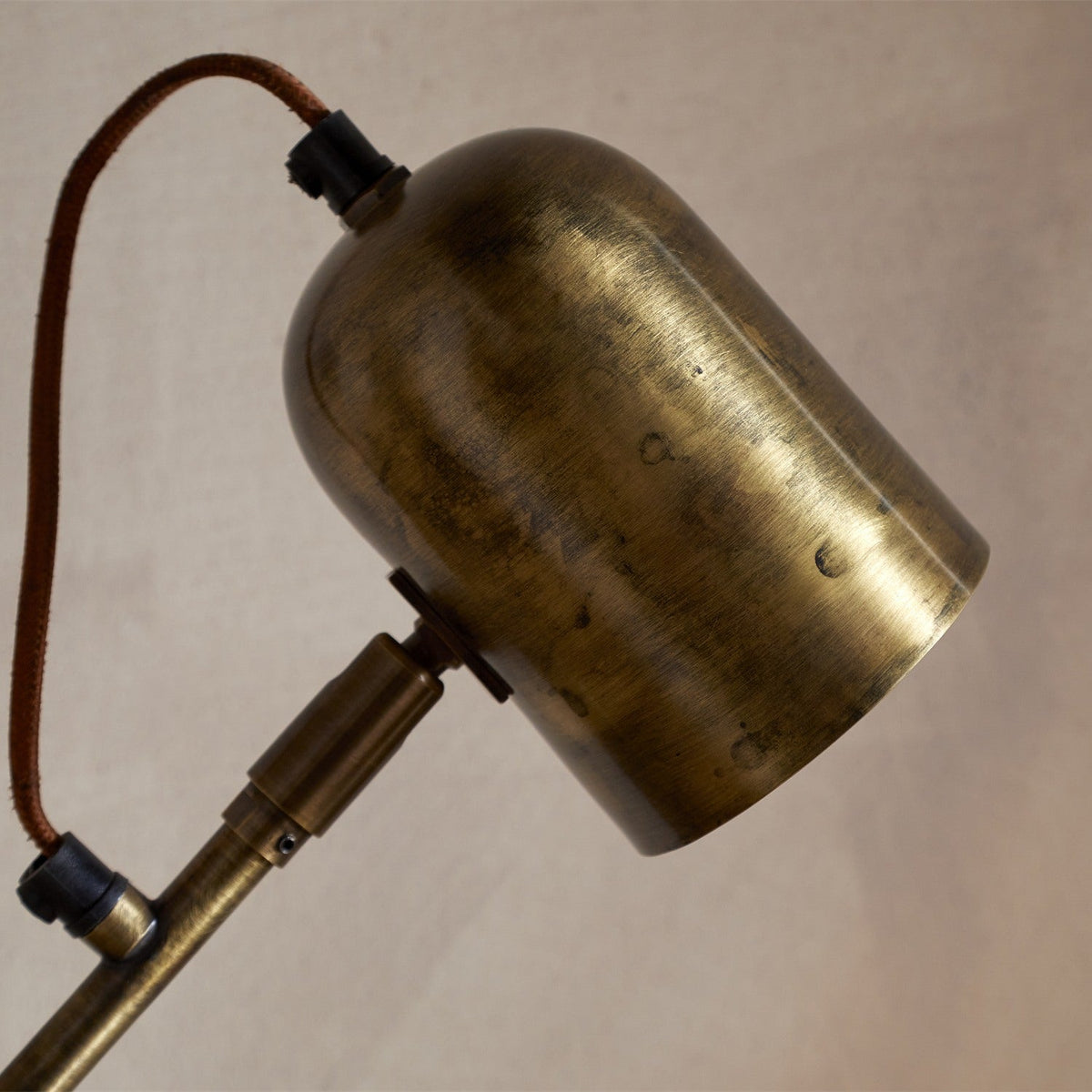 Thenkara Directional Desk Lamp - Antique Brass in a study, view 10