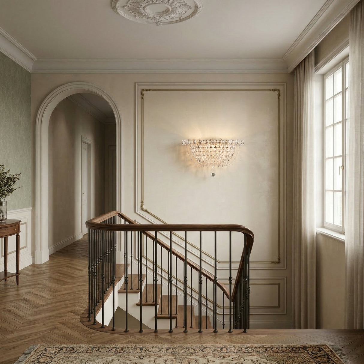 Elegant staircase with wooden handrail and black balusters in a softly lit hallway featuring light walls, a large window, crystal wall sconce, decorative ceiling molding, patterned rug, and the Amara 4 Light K9 Crystal Flush Ceiling Light in chrome.