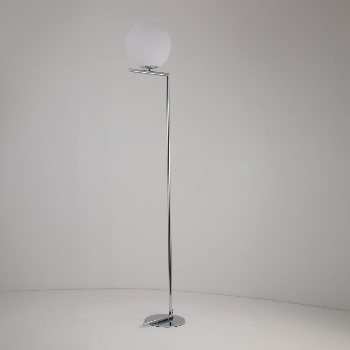 Niori Vetra 1 Light floor lamp with opal glass globe on a slim polished chrome arm and circular disc base, shown on a plain light background.