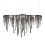 Niori Symphonia 10 light chandelier with stepped nickel canopy and cascading brass chains in a tapered veil silhouette, shown on a white background.