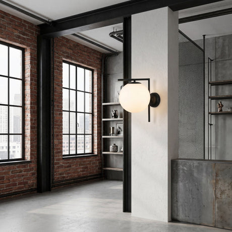 Modern industrial loft with exposed brick walls, large black-framed windows, and concrete floor, featuring the Vetra 1 Light Opal Glass Wall/Semi-Flush Ceiling Light in black mounted on a white wall.