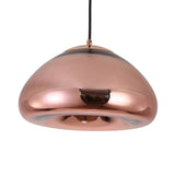 The Gulf Glass Pendant Light - Copper features a modern dome shape with a shiny copper finish, suspended from a black cord, and adds reflective brilliance and elegance to any space.