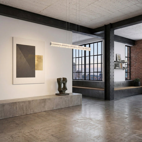Modern industrial-style loft with concrete floors, large windows, exposed brick and beams, abstract wall art, sculptural decor, minimalist shelving, and the Liora LED Crystal Suspension Light in chrome as the linear ceiling fixture.