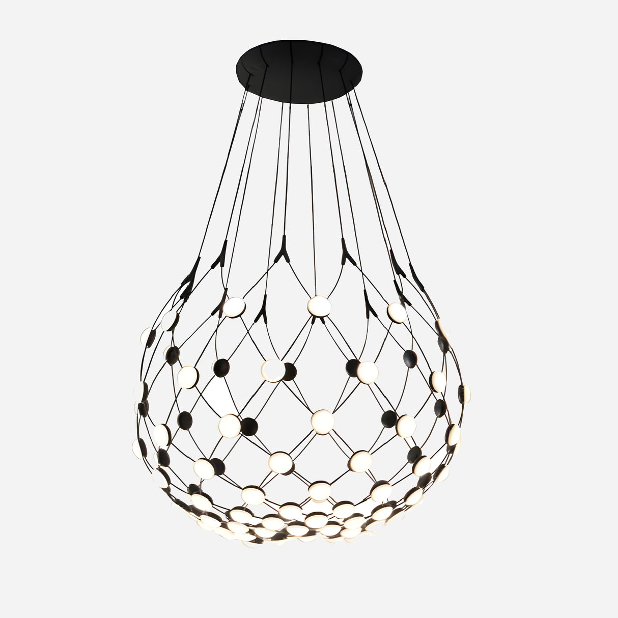 The Mesh LED Medium Suspension Light - Black showcases a semi-transparent design with interconnected wire strands and circular LEDs. This contemporary pendant offers uniform light distribution and hangs from a black ceiling plate set against a white background.