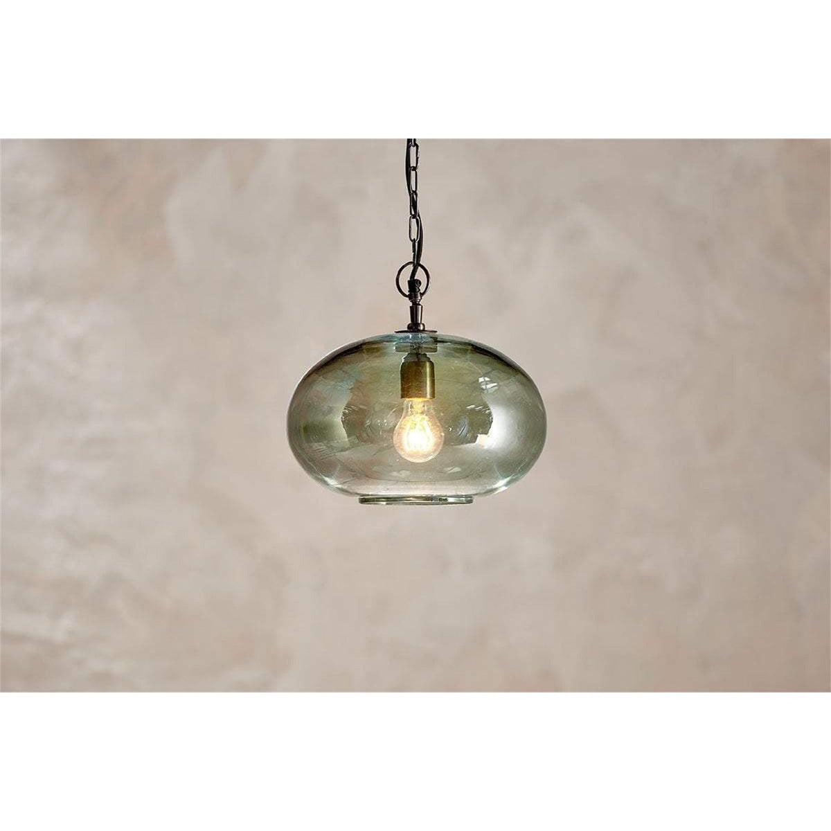 Otoro Small Round Recycled Glass Pendant Light in green, a flattened spherical glass shade with brass collar, hung from a black chain against a plain neutral backdrop.