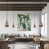 Droplet pendant light in copper finish, shown in a room setting