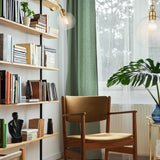 Chalice pendant light in brass finish, shown in a room setting