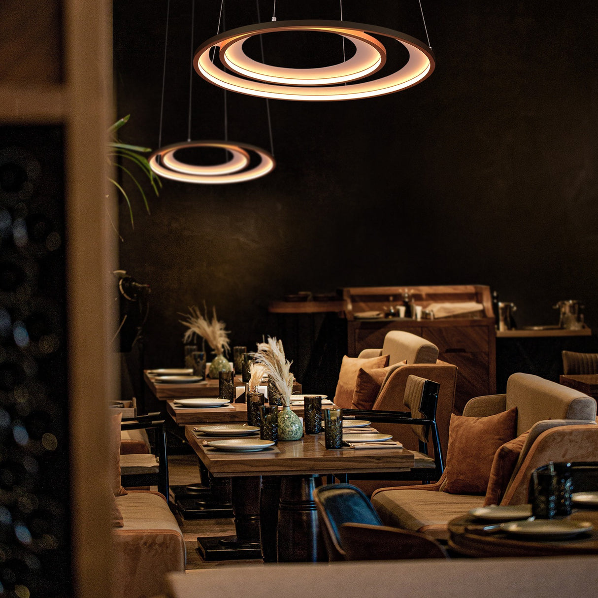 Halo pendant light in gold finish, shown in a room setting