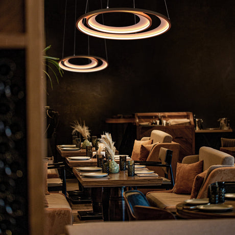 Halo pendant light in gold finish, shown in a room setting