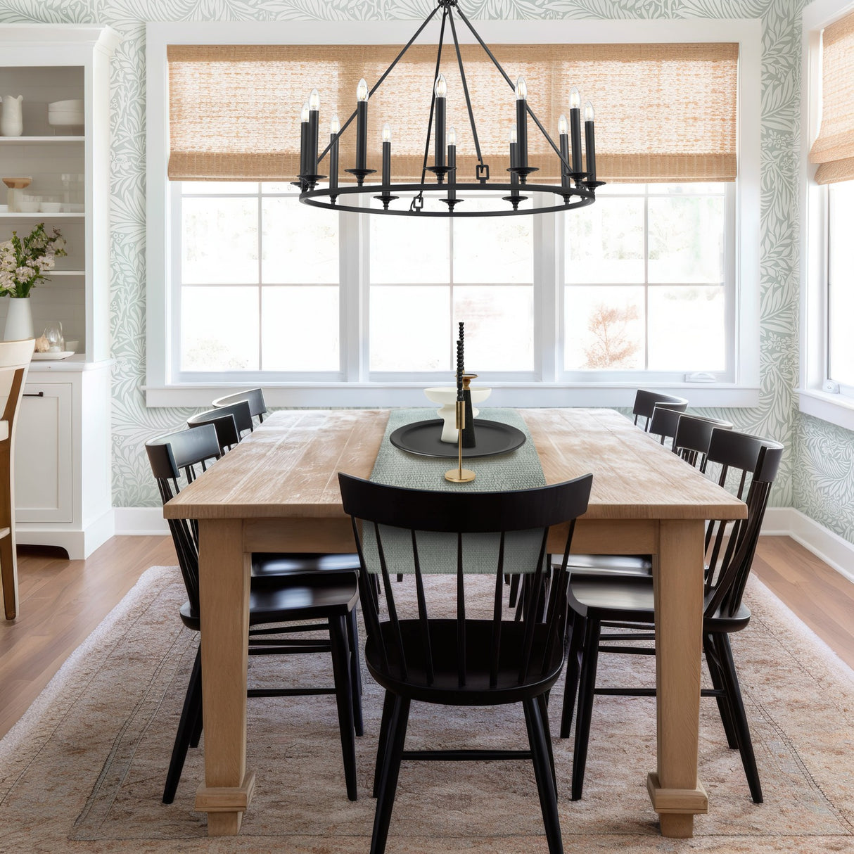 Tudor 12 light chandelier in black finish, shown in a room setting