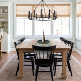 Tudor 12 light chandelier in black finish, shown in a room setting