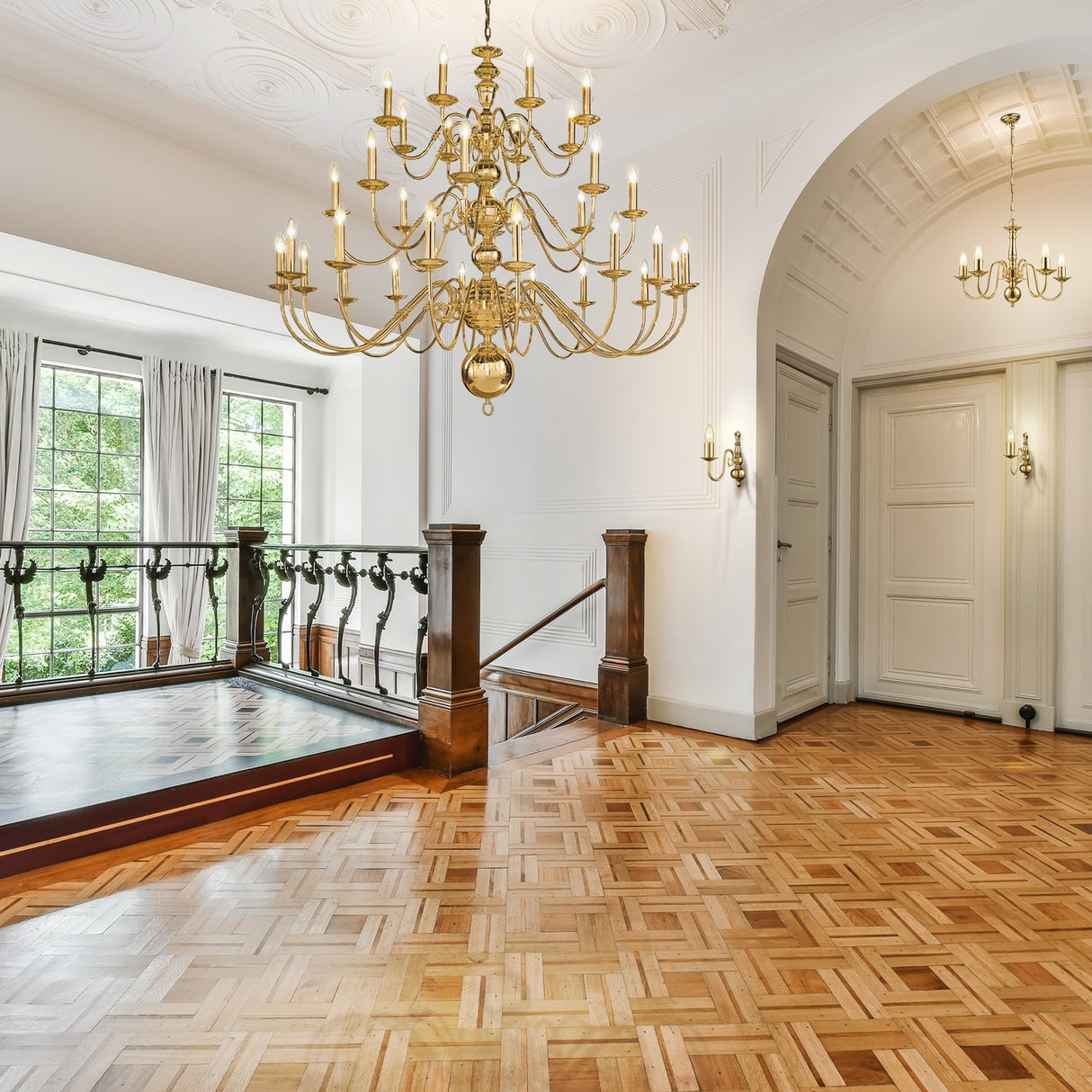Delft wall light in polished brass finish, shown in a room setting