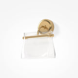 A transparent handbag hangs elegantly from a brass wall hook. The bags minimalistic design complements the Cabaret LED Curved Wall Light, which features a round base and smooth, polished finish, adding sophistication to the plain white background.