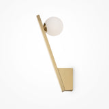 The Kazimir Wall Light - Gold With White Opal Glass showcases contemporary elegance with its minimalist design, featuring a tilted brass arm holding a frosted glass globe on a rectangular brass base against a plain white background.