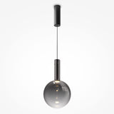 Introducing the Nebula LED Pendant Light 25cm - Black With Smoky Black Glass Sphere, a modern masterpiece with celestial charm. It features a smoky black glass bulb hanging from a sleek black cable and cylindrical fixture, popping against a white background.