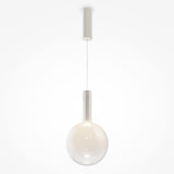 The Nebula LED Pendant Light 25cm showcases a misty white glass sphere and hangs gracefully by a thin wire from a sleek cylindrical mount, ideal for minimalist spaces.