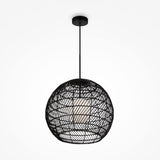 The Cane Pendant Light 40cm features a spherical black wicker structure with a woven lattice design and a white glass diffuser inside, offering a modern, stylish appearance with an organic touch.