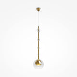 The Ros 1 Light Pendant features a modern design with a vertical brass rod and clear glass spheres descending from a gold ceiling mount, with the largest sphere housing a bulb at the bottom.