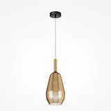 The Duality Teardrop Pendant Light boasts a black ceiling mount and mirrored gold glass teardrop-shaped shade. Its translucent design elegantly filters light, suspended from a sleek white cord, exemplifying exquisite modern lighting.