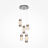 The Drop LED Cluster Pendant Light 80W 3000K - Chrome features eight spherical LED lights hanging at varying lengths from a circular base, combining chrome and textured glass to emit an energy-efficient, soft warm glow.
