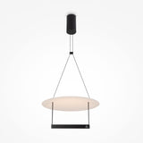 The Ambience LED Round Flat Small Pendant Light - Black features an energy-efficient, minimalist design with a glowing circular white shade and black cords from a cylindrical black ceiling mount, exuding modern elegance against a plain white background.