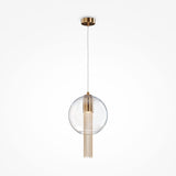 The Flusso Long Chain Pendant Light features a clear glass ball with a brass fixture, complemented by vertically hanging thin bronze-finished chains for an elegant and contemporary design.
