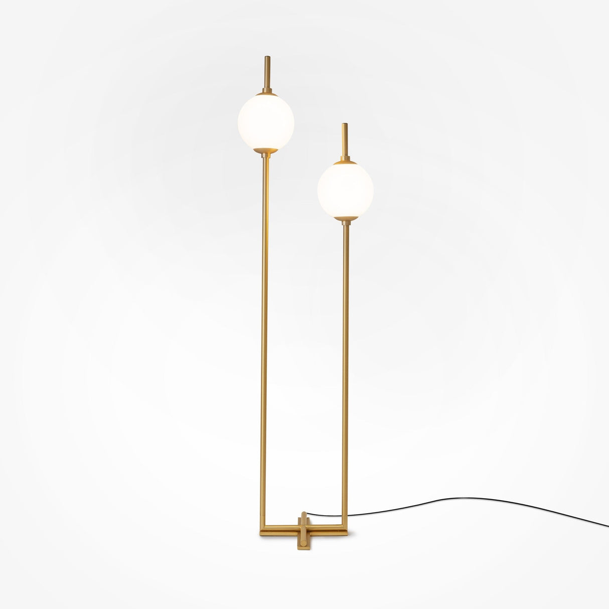The Sixth Sense 2 Light LED Floor Lamp features two spherical white glass shades at different heights on sleek brass-finished metallic rods, resting on a square base. A black cord complements its design, enhancing ambient lighting against a plain white background.