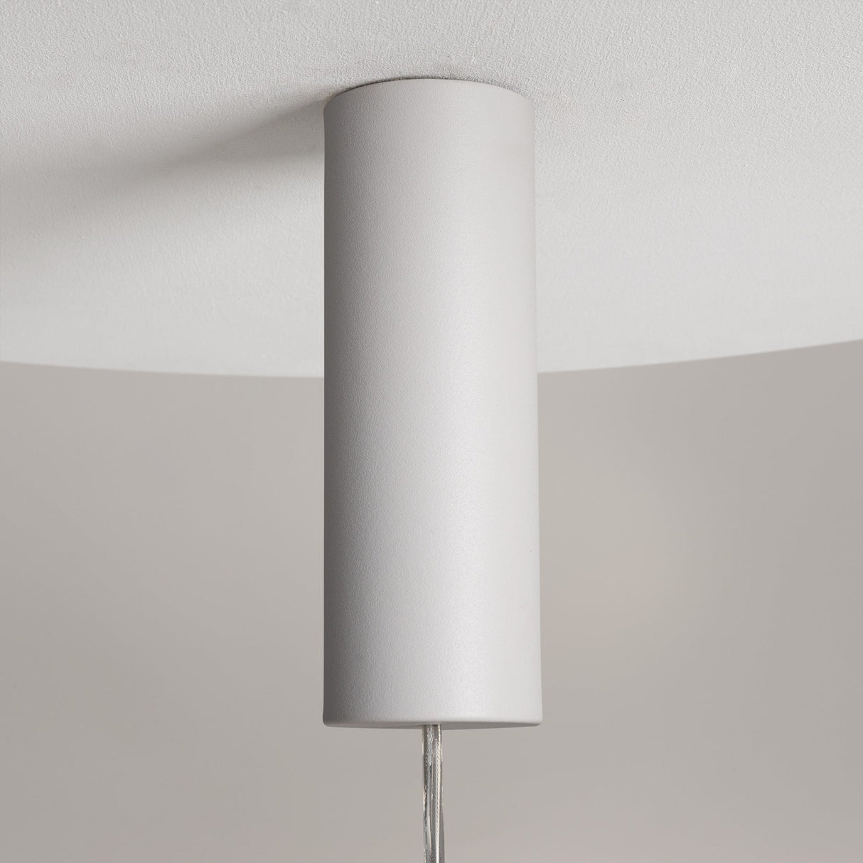 Close-up of the minimalist Nebula LED Pendant Light 20cm in white, featuring a misty white glass sphere design against a light gray background. This energy-efficient fixture has a smooth surface, centrally suspended and casting an elegant glow.