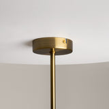 The Miracle 3 Light Pendant, crafted in brass with clear glass shades, descends from a white ceiling via a sleek metal rod. Its minimalistic design exudes contemporary style, enhanced by the warm brass tone against the neutral backdrop.