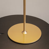 Close-up of the AI Collaboration Rechargeable LED Table Lamp - Gold with its pole centered on a gold base, contrasting against the matte black tabletop.