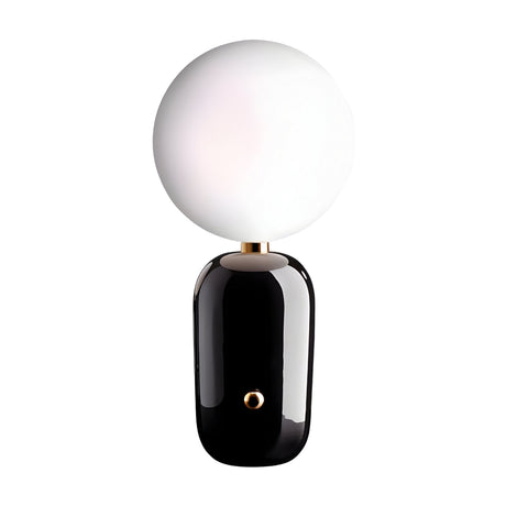 The Pallo Table Lamp - Black features a glossy black cylindrical base and a large round opal glass diffuser, displayed against a plain white background.