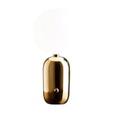 The Pallo Table Lamp - Gold features a shiny gold cylindrical base and a large round opal glass diffuser, photographed against a plain white background.