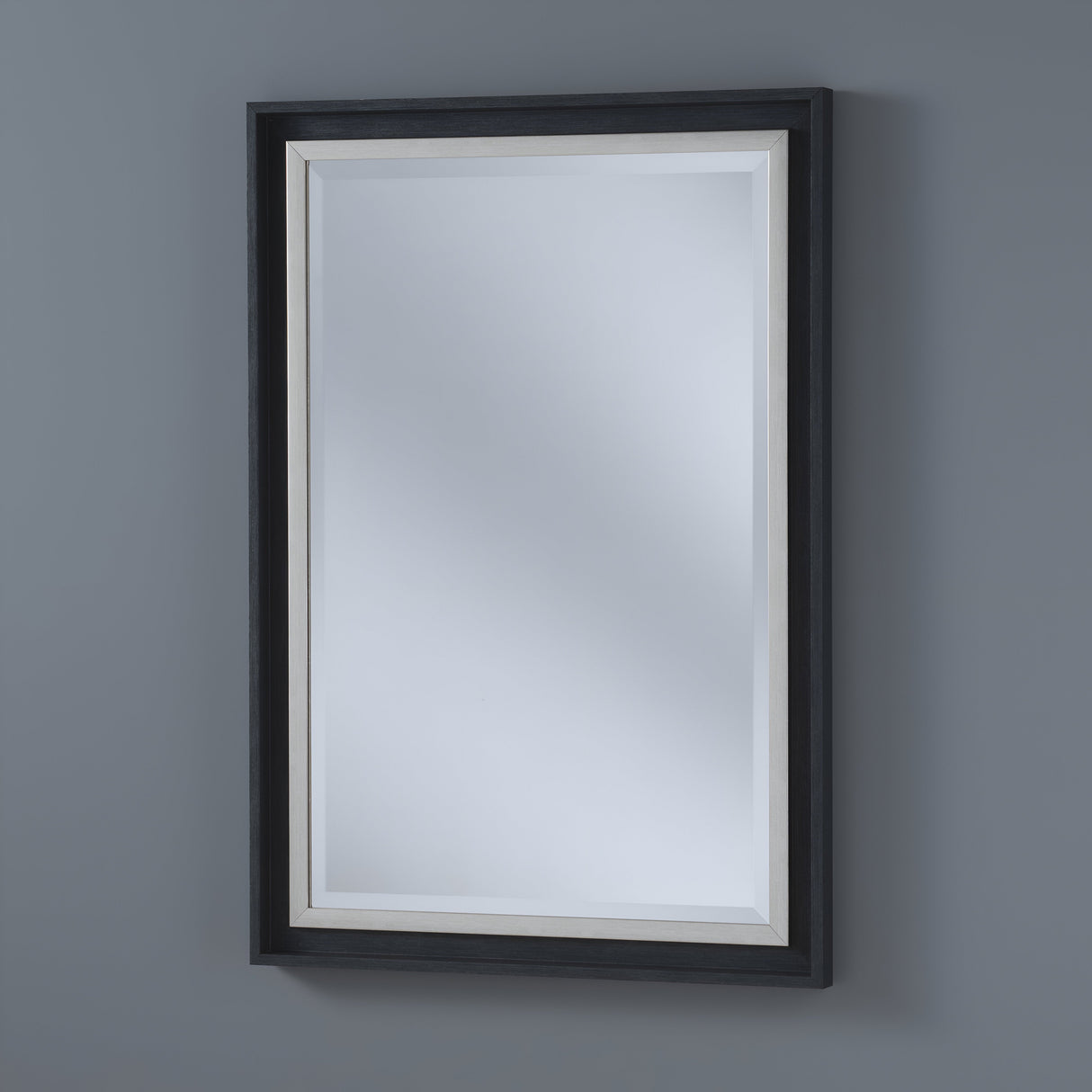 The Artivis Rectangle Wall Mirror, featuring a black frame and beveled edge, elegantly enhances the plain gray wall with its modern minimalist design that subtly reflects light for a clean, understated look.