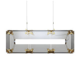 Niori Qbic LED Small Linear Suspension Light with rectangular clear glass shell, brass corner brackets, central LED tube, and twin steel cables.
