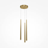 The Cascade CCT Dimmable LED Cluster Pendant Light features three elongated brass pendants hanging from a round mount. With sleek cables, this modern fixture showcases elegance, each pendant tapering to a rounded end against a plain white background.