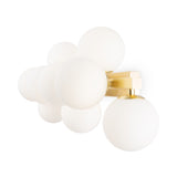 The Dallas 9 Light Wall Light combines an elegant brass base with clustered white opal glass globes, providing ambient lighting and a contemporary design.