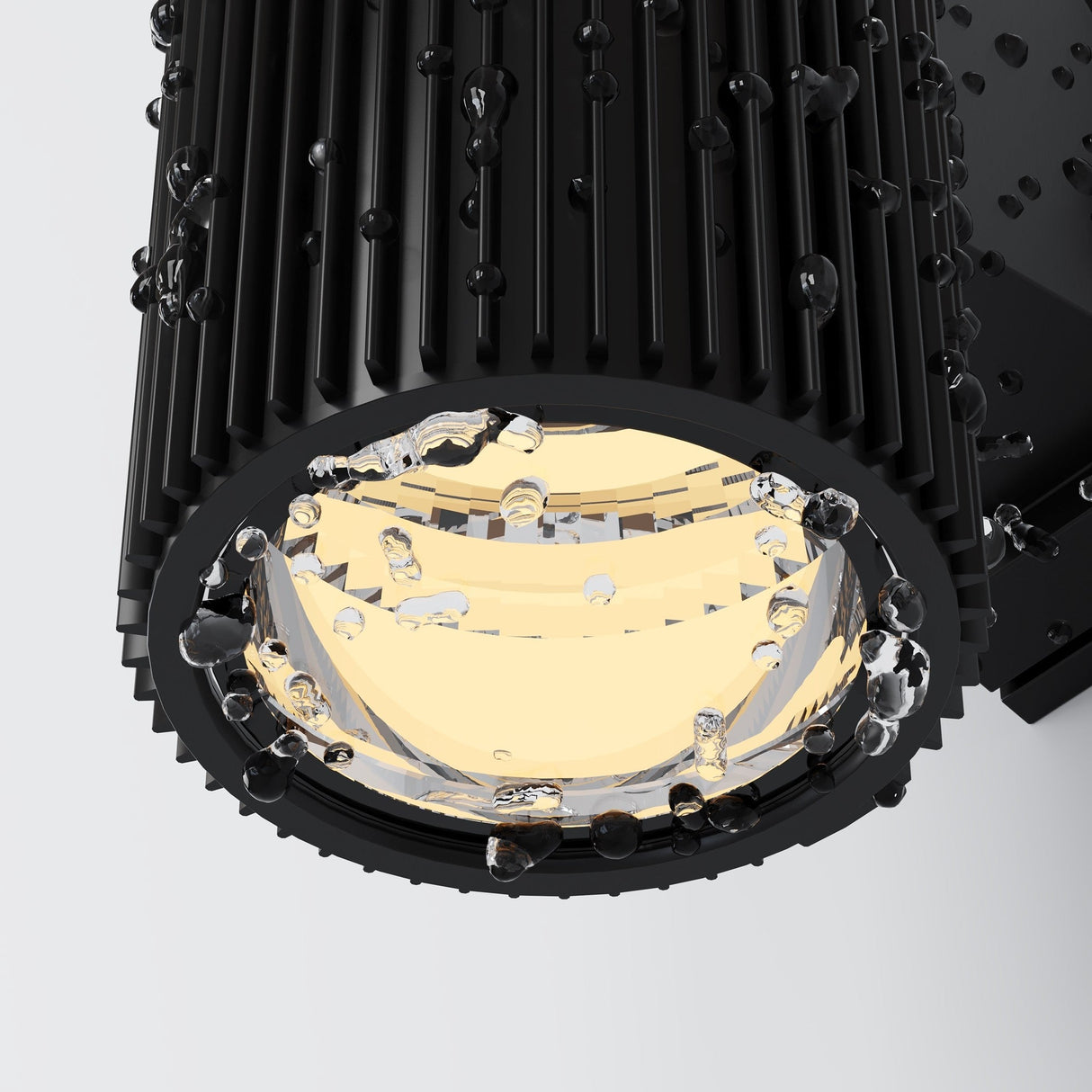 The Rando Outdoor Up & Down Wall Light in black features a modern cylindrical design with a matte, textured finish. Its inner reflective surface elegantly catches light amidst water droplets, delivering stylish up-and-down illumination for a sleek, industrial look.
