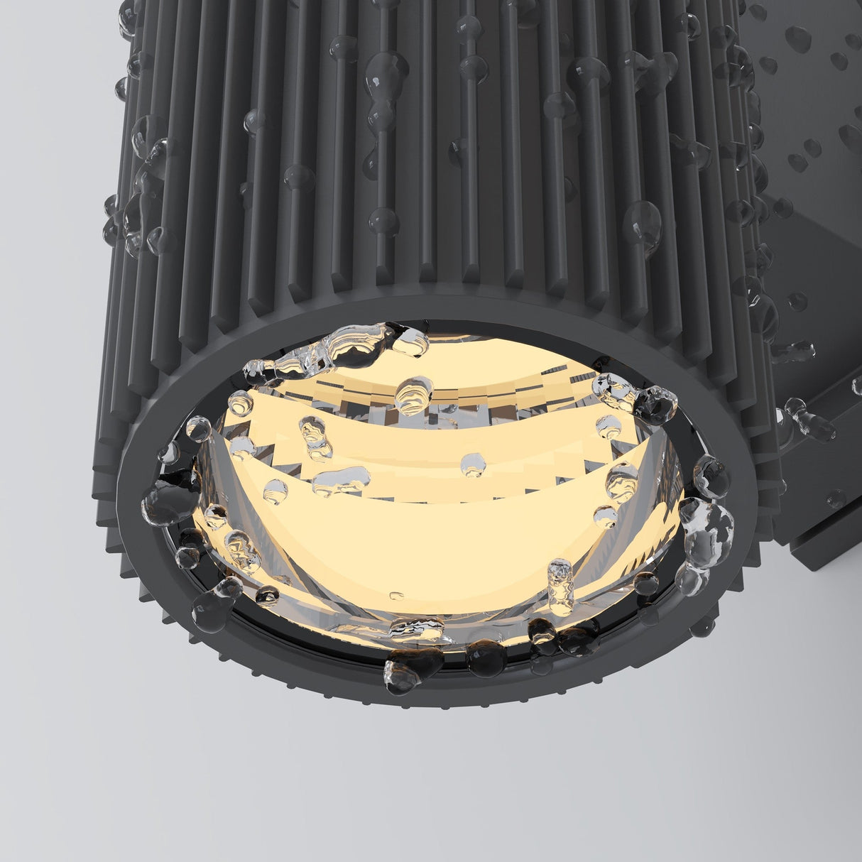 Close-up of the sleek, corrosion-resistant Rando Outdoor Up & Down Wall Light in grey, adorned with water droplets. The illuminated fixture casts a warm glow, emphasizing the textured ridges on its dark cylindrical design.
