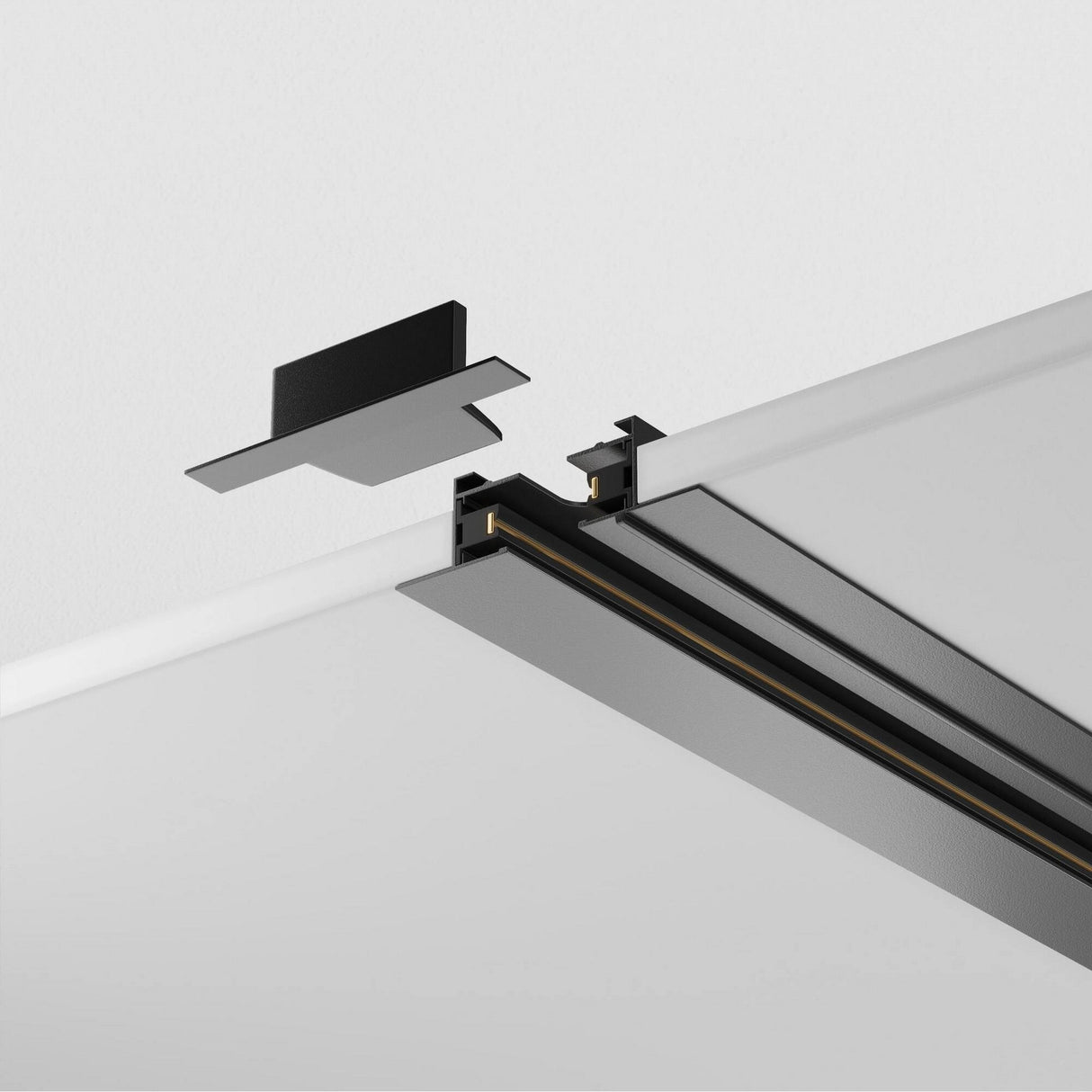 The Unity Single Phase Recessed Track 1m in black is a modern ceiling-mounted system featuring an aluminum body with a linear light fixture, partially installed into the track, and topped by a black cover piece prepared for installation.