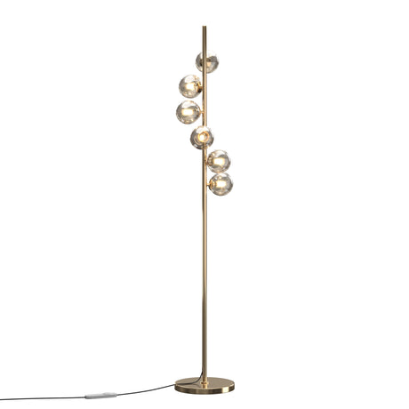 Maytoni Dallas 6 light floor lamp with smoke glass globes staggered along a brushed gold vertical pole on a circular base, plain background.