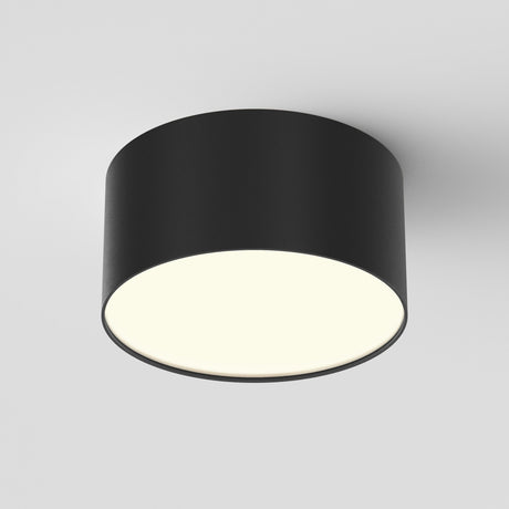 The Zon LED Downlight 3000K 12W in black features a modern circular design with a matte finish and provides bright ambient lighting, mounted seamlessly against a plain white ceiling for a minimalist aesthetic.