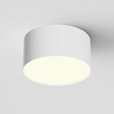 The Zon LED Downlight 3000K 12W - White features a sleek, cylindrical ceiling design with aluminum construction and emits a soft, even glow from its flat underside, beautifully illuminating the surrounding area.