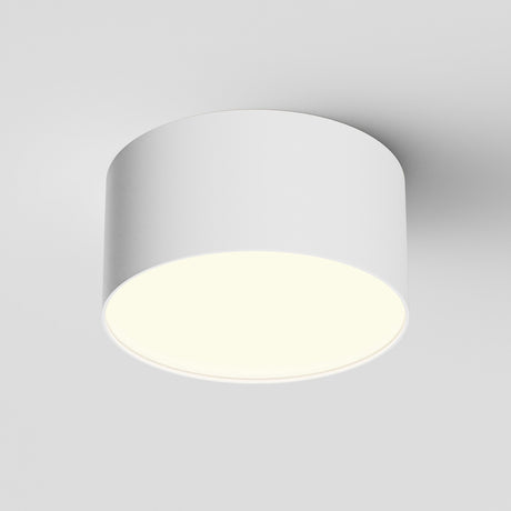 The Zon LED Downlight 3000K 12W - White features a sleek, cylindrical ceiling design with aluminum construction and emits a soft, even glow from its flat underside, beautifully illuminating the surrounding area.