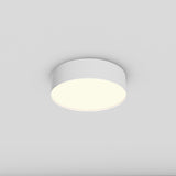 The Zon LED Flush Ceiling Light 3000K 26W - White is installed on a simple white ceiling, offering an energy-efficient, soft warm glow that gently contrasts with the surroundings.