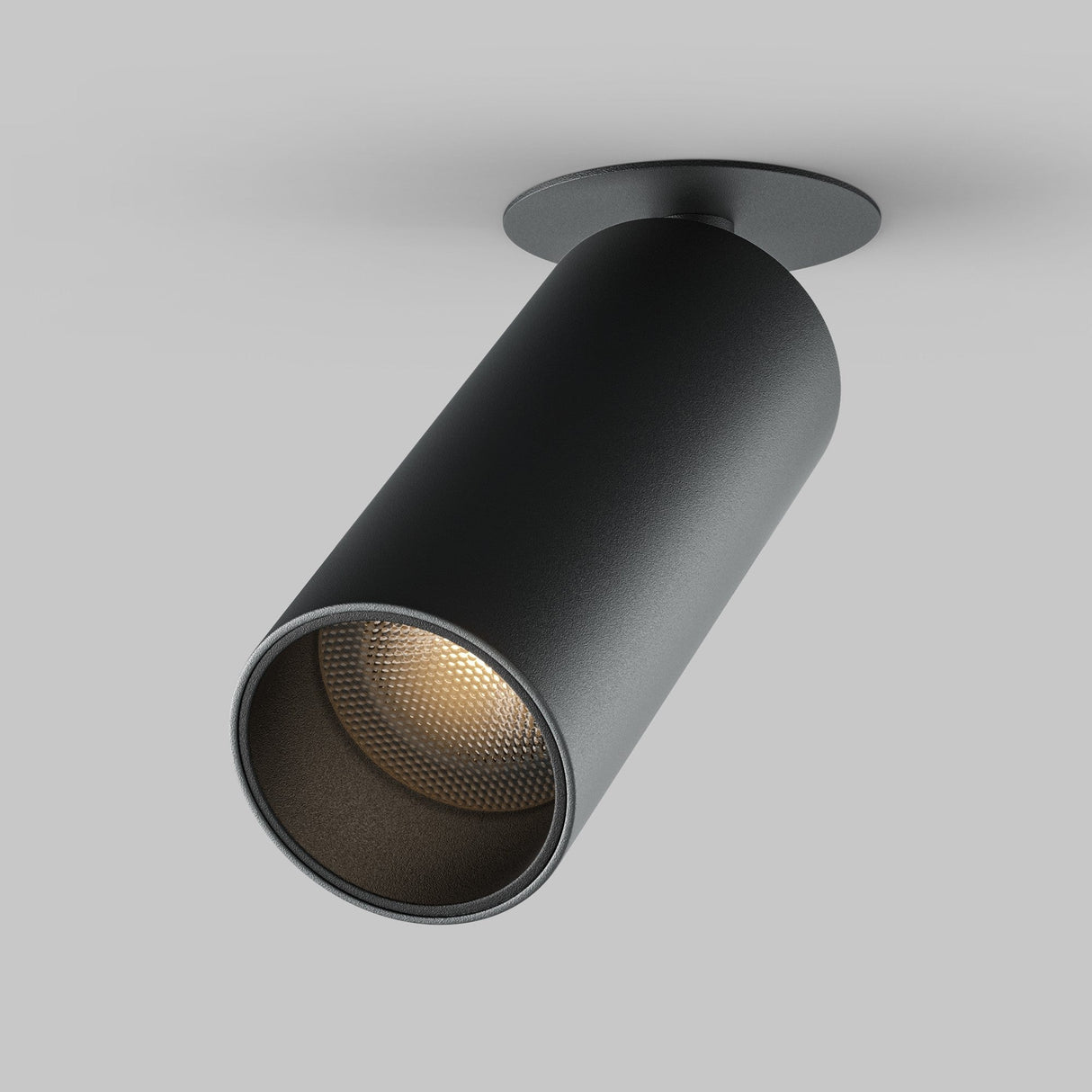The Focus LED Single Recessed Spotlight 12W 3000K in black is ceiling-mounted, energy-efficient, cylindrical, and illuminated. It is angled downwards against a plain gray background.