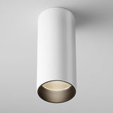 The Focus LED Fixed Round Surface Mounted Downlight 12W 3000K in white is a cylindrical ceiling fixture with a recessed LED that illuminates against a pale gray background. This modern lighting solution offers a sleek, minimalist aesthetic.