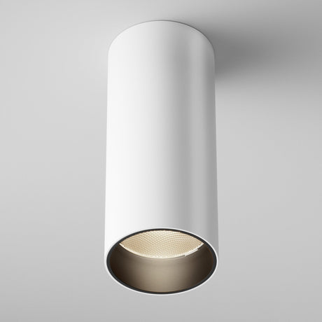 The Focus LED Fixed Round Surface Mounted Downlight 12W 3000K in white is a cylindrical ceiling fixture with a recessed LED that illuminates against a pale gray background. This modern lighting solution offers a sleek, minimalist aesthetic.