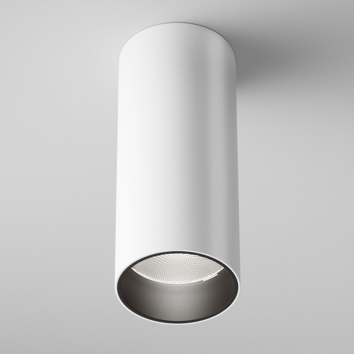 The Focus LED Dimmable Fixed Round Surface Mounted Downlight 12W 4000K in white offers a modern, cylindrical design with an open bottom showcasing the LED downlight. Ideal for energy-efficient lighting, it features a clean, minimalist style against a white background.